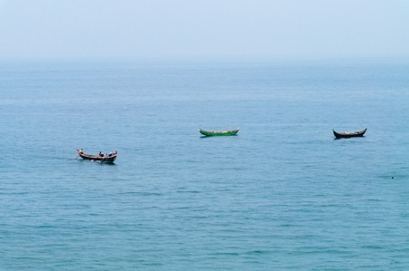 Traditional wooden fishing boats in the ocean. Kovalam. Kerala. Indiaの写真素材