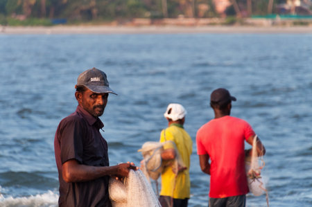 Fort Kochi, India - Jan 6, 2015: Unidentified Indian Fisherman with net on the beach of Fort Kochi....