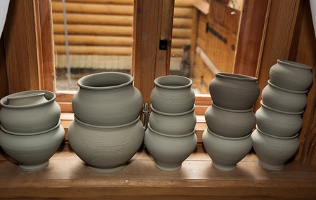 Handmade clay pots on the wooden window