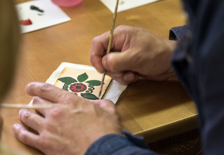 Gorodets,  Russia - May 3, 2015: The artist paints Gorodets painting in City of Craftsmen. Gorodets painting is one of the folk arts and crafts of Russia.のeditorial素材