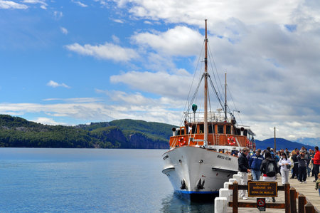 San Carlos De Bariloche , Argentina - Jan 21, 2011: Tourists boat at the pier in Lake Nahuel Huapi. Los Arrayanes National Park.のeditorial素材