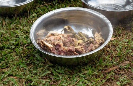 Hot cooked buffalo meat on the plate for the guests at funeral ceremony. In Toraja the funeral ritual is the most elaborate and expensive even. Tana Toraja. South Sulawesi, Indonesiaの写真素材