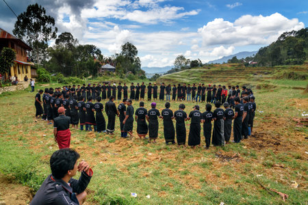 Tana Toraja, Indonesia - Dec 10, 2015: Ma'badong a ceremonial dance. Men dancing and singing at the funeral ceremony. In Toraja the funeral ritual is the most elaborate and expensive even. South Sulawesiのeditorial素材