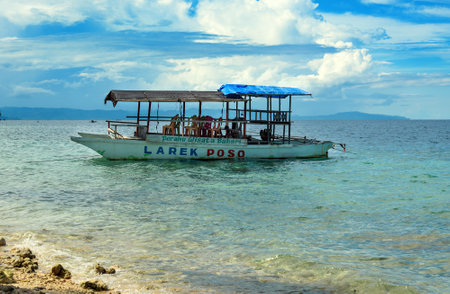 Poso, Indonesia - Dec 13, 2015: Tourist boat on the beach near Poso city.  Central Sulawesi. Indonesiaのeditorial素材