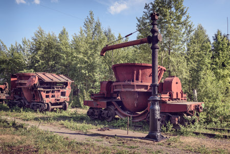 Old steel buckets to transport the molten iron, mounted on railway platforms on Mining and metallurgical plantのeditorial素材