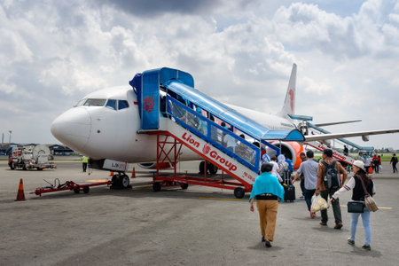 Jakarta, Indonesia - Dec 28, 2015: Passengers entering an Lion Air airplane at Soekarno-Hatta International Airport. Lion Air is an Indonesian low-cost carrierのeditorial素材