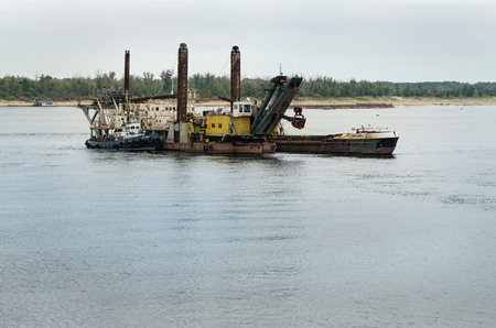 Volgograd, Russia - August 31, 2016: Dredging platform and cargo ship on Volga riverのeditorial素材