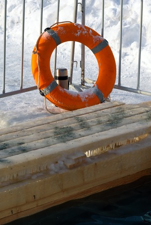 Lifebuoy near Ice-hole for bathing into cold water on Epiphany day. Russiaの写真素材