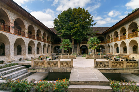 Sheki, Azerbaijan - September 13, 2016: View of the inner courtyard of Upper caravanserai is a historical monument in Sheki 18th-19th centuries. It was used by merchants to store their goods in cellars, who traded on the first floor, and lived on the secoのeditorial素材
