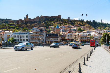 Tbilisi, Georgia - September 24, 2016: View of Metekhi Bridge and Old city with shops, restaurants...
