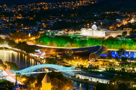 Night view of center Tbilisi city. Cityscape with evening illumination and famous landmarks from...