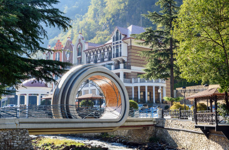 Borjomi, Georgia - October 02, 2016: Modern bridge over Borjomula river. In the background Luxury hotel complexのeditorial素材
