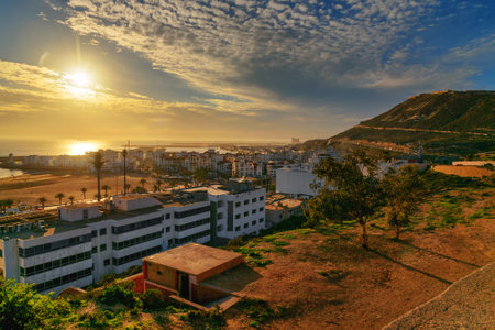View of long, wide beach in Agadir city at sunset, Morocco. The hill bears the inscription in Arabic: God, Country, Kingのeditorial素材