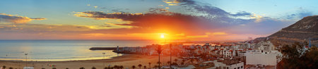 Panorama view of long, wide beach in Agadir city at sunset, Morocco. The hill bears the inscription in Arabic: God, Country, Kingのeditorial素材