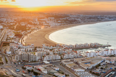 View of long, wide beach in Agadir city at sunrise, Morocco.のeditorial素材