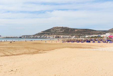 Long, wide beach in Agadir city, Morocco. The hill bears the inscription in Arabic: God, Country, Kingのeditorial素材