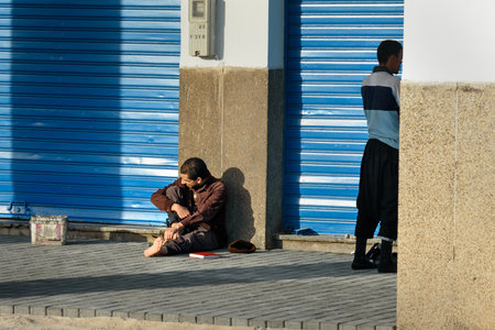 Agadir, Morocco - December 24, 2016: Moroccan man sitting on road at the streetのeditorial素材