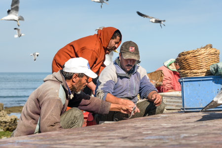 Essaouira, Morocco - December 31, 2016: Local fisherean cleaning fresh fish in portのeditorial素材