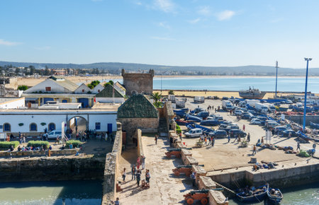 Essaouira, Morocco - December 31, 2016: View of Old Fortress Sqala du Port and port whith blue fishing boatsのeditorial素材