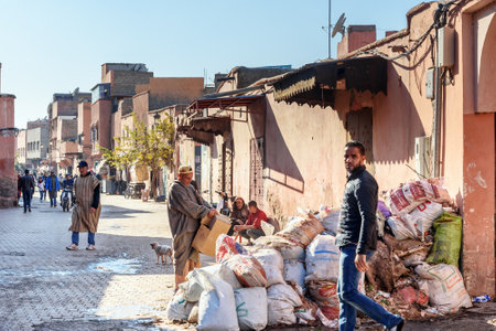 Marrakech, Morocco - December 28, 2017: Moroccan people on the street in medina at Marrakesh