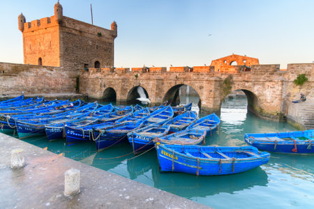 Essaouira, Morocco - January 01, 2017: View of Old Fortress Sqala du Port and blue fishing boatsのeditorial素材
