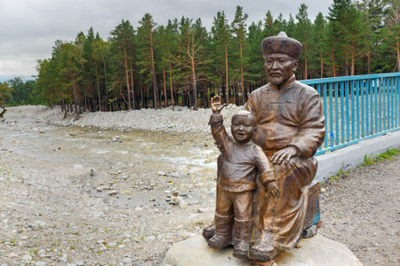 Arshan, Russia - August 15, 2017: Statue of Man with Child at the bridge over the Kyngyrga River. Buryatiaのeditorial素材