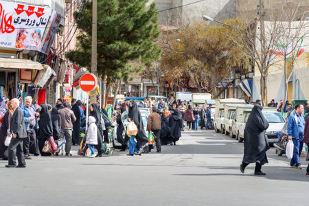 Tabriz, East Azerbaijan province, Iran - March 15, 2018: People walk on the street in the center of...