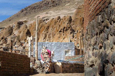 Kandovan, East Azerbaijan province, Iran - March 16, 2018: Iranian woman on the street in rock...