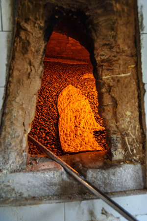 Iranian traditional bread Sangak in the oven on pebbles in small bakery. Khorramabad. Iranのeditorial素材