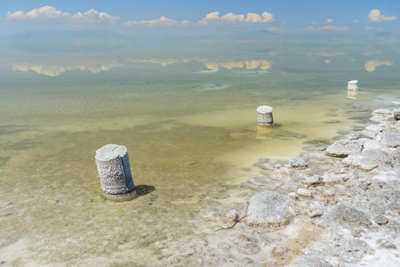 Wooden pillars with crystallized salt on Urmia Salt Lake. it was the largest lake in the Middle East, now on the verge of extinction. Iranの写真素材
