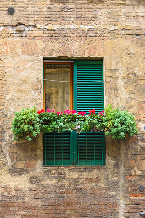 Traditional window with wooden shutters of old house in Siena. Italyの写真素材