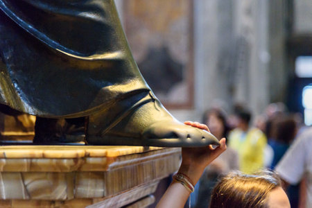 Vatican city, Vatican - October 05, 2018: Person touching the foot of Saint Peter statue. Interior of Saint Peter's Basilicaのeditorial素材