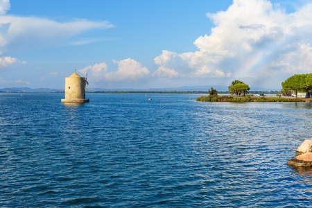 Old Spanish windmill in lagoon Orbetello on peninsula Argentario in Tuscany. Italy