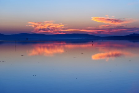 View sunrise in lagoon Orbetello on peninsula Argentario in Tuscany. Italy