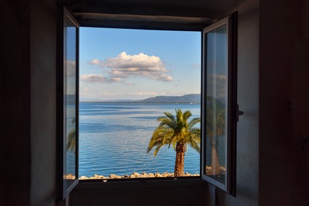 View of the sea and sky through the window. Porto Santo Stefano in Monte Argentario. Tuscany. Italy