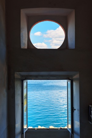 View of the sea and sky through the window. Porto Santo Stefano in Monte Argentario. Tuscany. Italy
