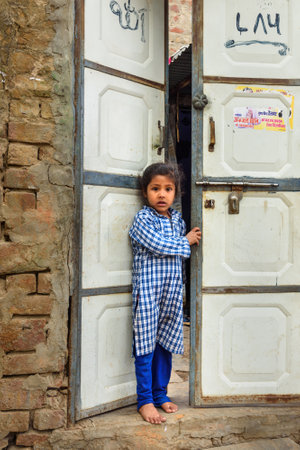 Amer village, India - January 30, 2019: Portrait of young indian girl near the doors in Amber village. Rajasthanのeditorial素材