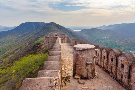 Amber village, India - January 30, 2019: Group of indian guys on ancient long wall with towers around Amber Fort. Rajasthan. Indiaのeditorial素材