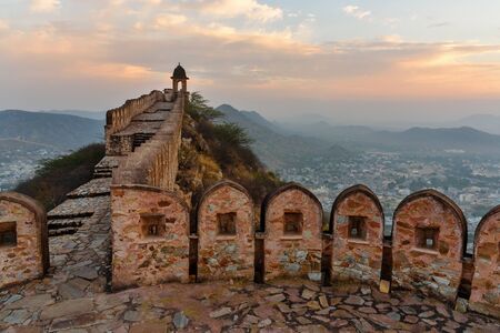 Ancient long wall with towers around Amber Fort at morning. Jaipur. Rajasthan. India