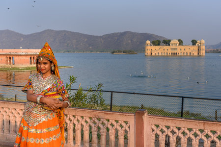 Jaipur, India - February 01, 2019: Girl in traditional dress for taking pictures front of Jal Mahal, Water Palace in Jaipur. Rajasthanのeditorial素材