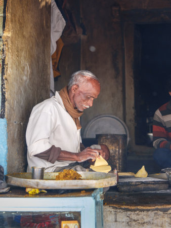 Sambhar, India - February 03, 2019: Indian man preparing samosas with vegetarian ingredients on the street in Sambhar Lake Village. Rajasthanのeditorial素材
