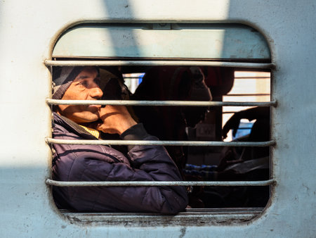 Sambhar, India - February 05, 2019: Elderly man is sitting in train, and looking through the train window. Rajasthanのeditorial素材