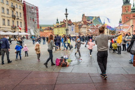 Warsaw, Poland - November 12, 2018: Women launch soap bubbles on Castle Square in old townのeditorial素材