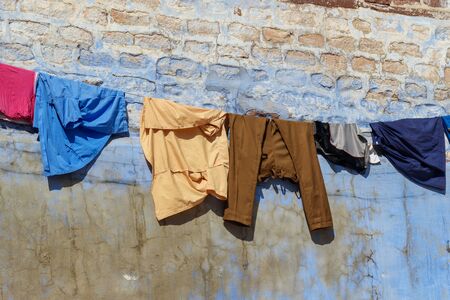 Clothes dry on rope on the street of the Blue City of Jodhpur. Rajasthan. Indiaの写真素材