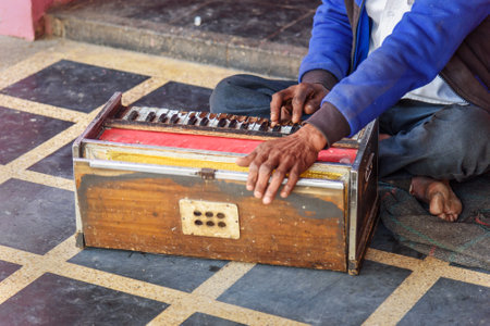 Deshnok, India - February 11, 2019: Indian man playing the Harmonium in Karni Mata Temple or Rats Temple in Deshnok. Rajasthanのeditorial素材