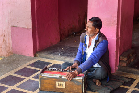 Deshnok, India - February 11, 2019: Indian man playing the Harmonium in Karni Mata Temple or Rats Temple in Deshnok. Rajasthanのeditorial素材