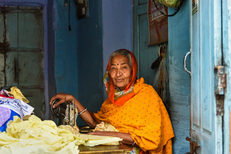 Bikaner, India - February 12, 2019: Indian woman tailor at work place with sewing machine in Bikaner. Rajasthanのeditorial素材