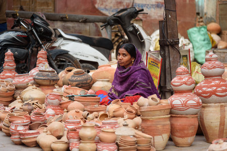 Bikaner, India - February 11, 2019: Indian woman selling clay pots on local market in Bikaner. Rajasthanのeditorial素材