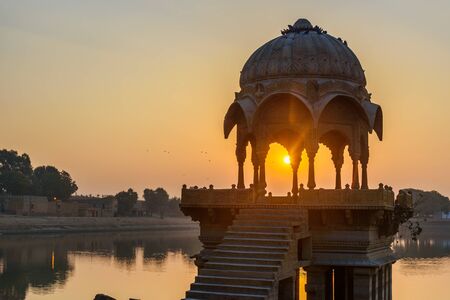 Gadisar lake in the morning at sunrise. Man-made water reservoir with temples in Jaisalmer. Rajasthan. Indiaの写真素材