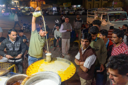 Jaisalmer, India - February 16, 2019: Indian vendor preparing hot sweet milk with almond on the street in Jaisalmer. Rajasthanのeditorial素材